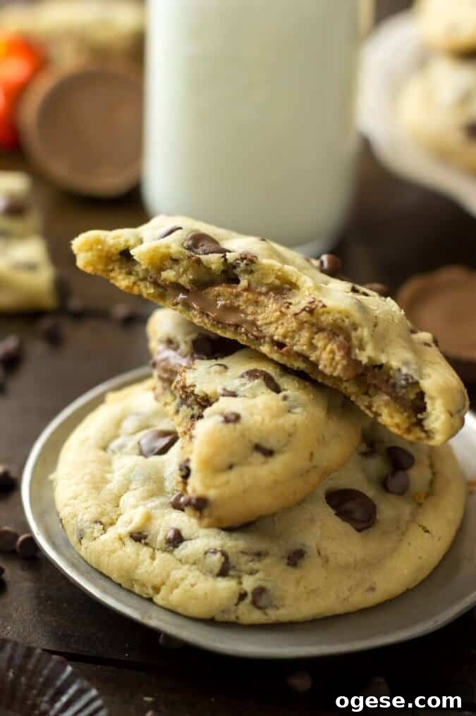 Nutella-Filled Chocolate Chip Cookies 8 Peanut butter cup stuffed chocolate chip cookies, stacked on a plate