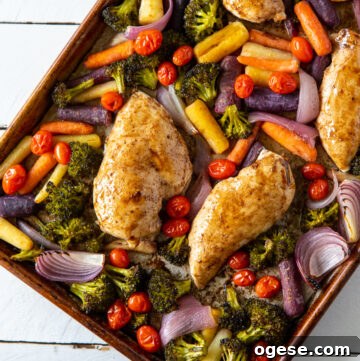 Close up of chicken and vegetables on a sheet pan.