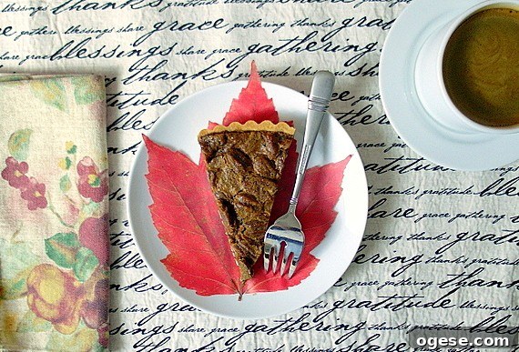 Coffee Pecan Tart with Orange Shortbread Crust Recipe 7 An overhead shot of a slice of coffee pecan tart with a cup of coffee.