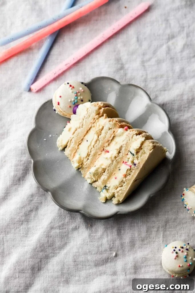 slice of macaron birthday cake on a plate