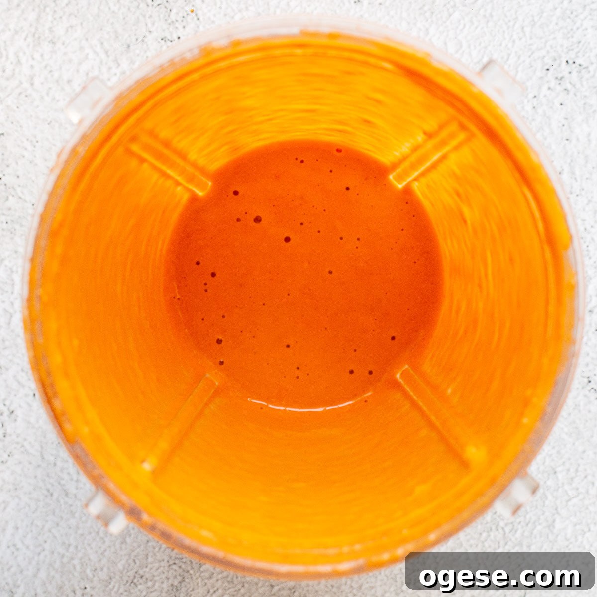 Orange sauce in a blender jar.