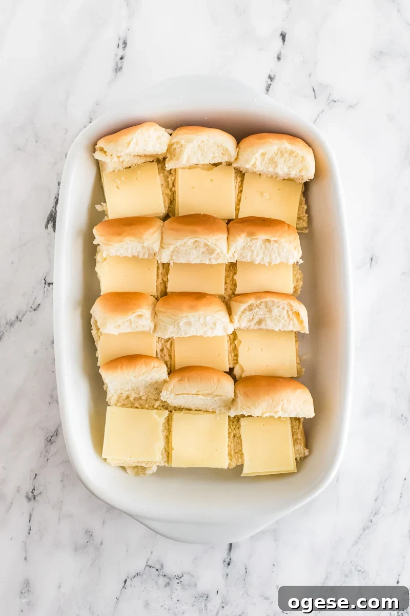 Ultimate Cheesy Ham and Melted Cheese Sliders Recipe 7 Cheese is added to the slider buns.