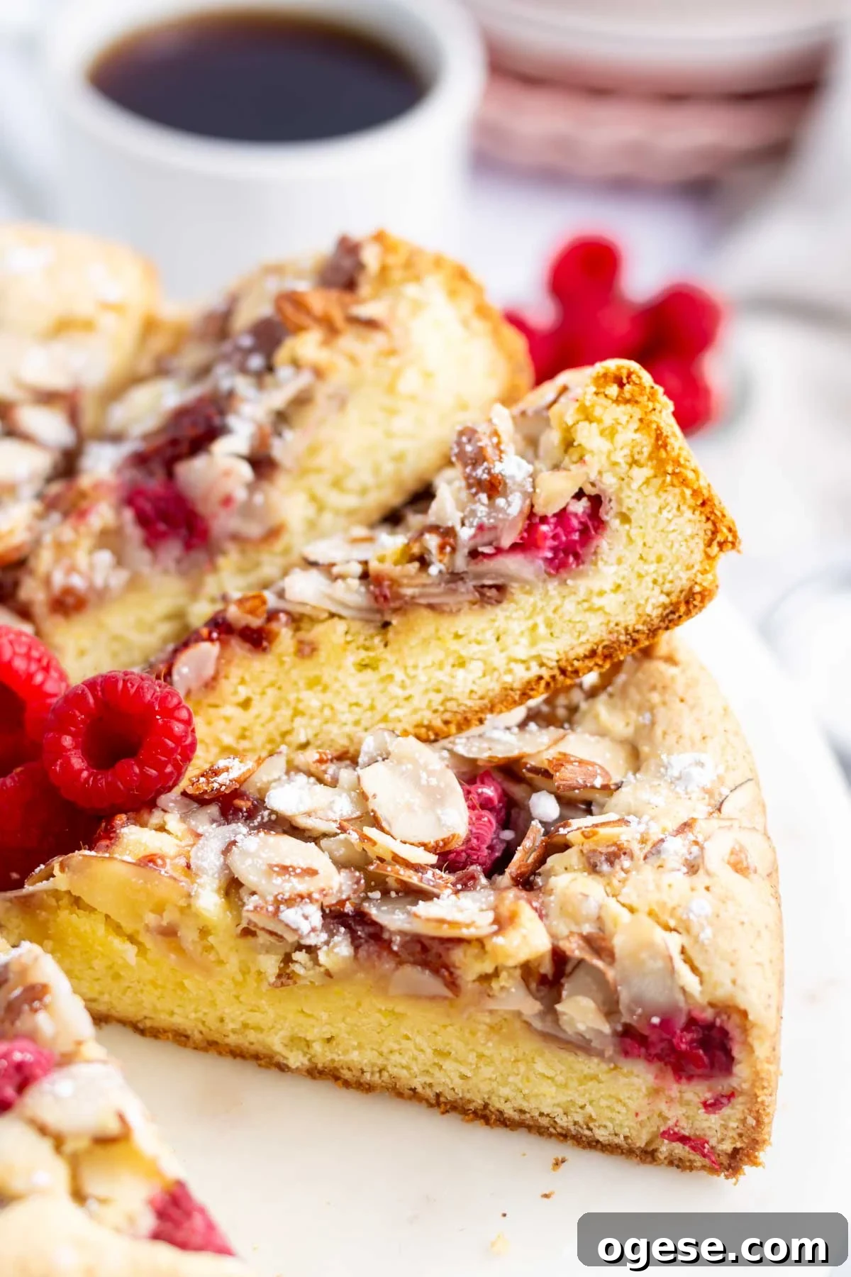 slices of cake showing the tender crumb and crunchy almond raspberry topping