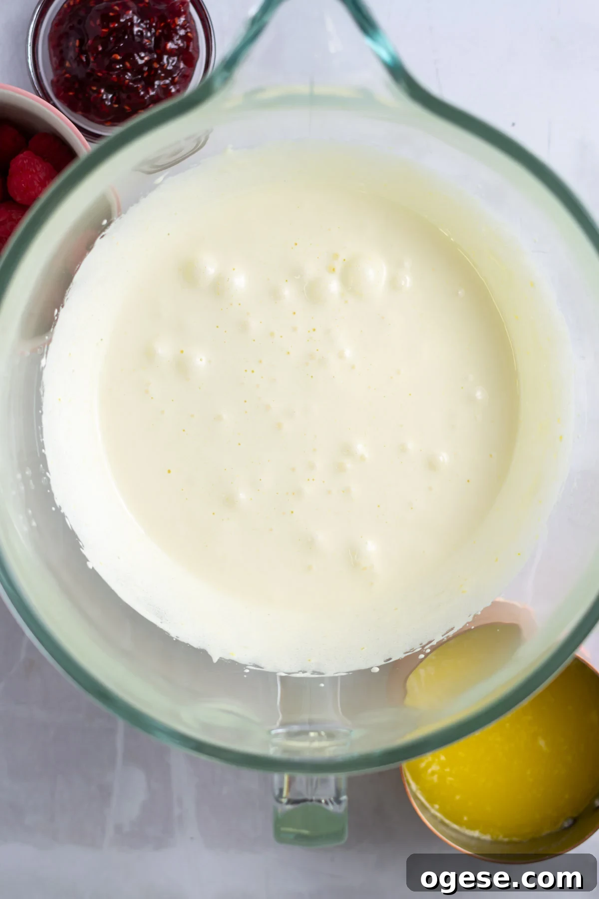 Egg, egg yolks and sugar whipped together in a mixing bowl.