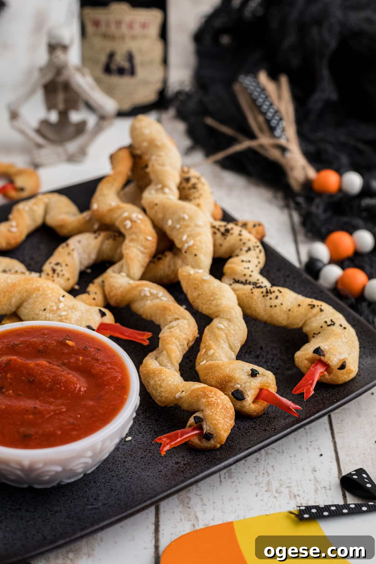 Crispy Breadstick Rattlers: Spicy Sausage-Stuffed Appetizers 2 A side angled shot of a plate full of breadstick rattlers for Halloween.