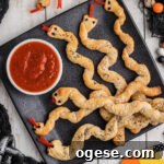 Crispy Breadstick Rattlers: Spicy Sausage-Stuffed Appetizers 16 A plate full of breadstick rattlers with a marinara sauce to dip.