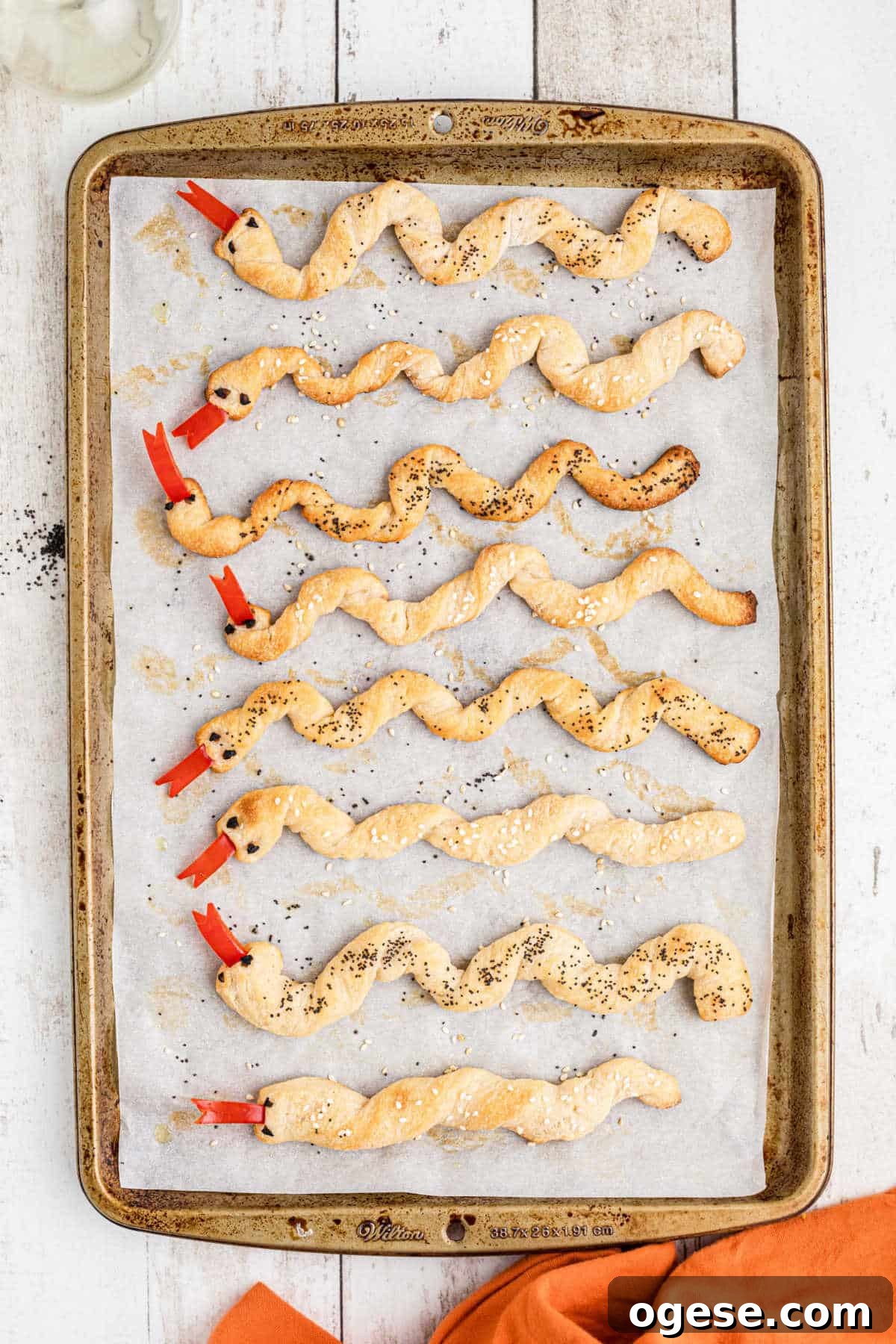 Crispy Breadstick Rattlers: Spicy Sausage-Stuffed Appetizers 8 A baking sheet with finished breadstick snakes.