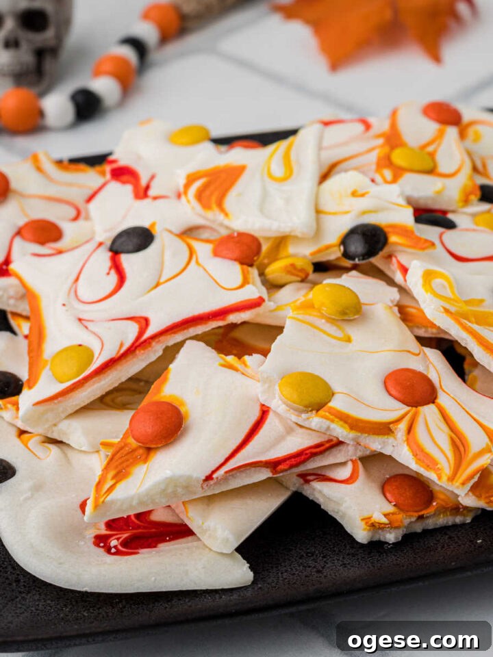A plate with chocolate bark broken up into pieces, with fall colors.