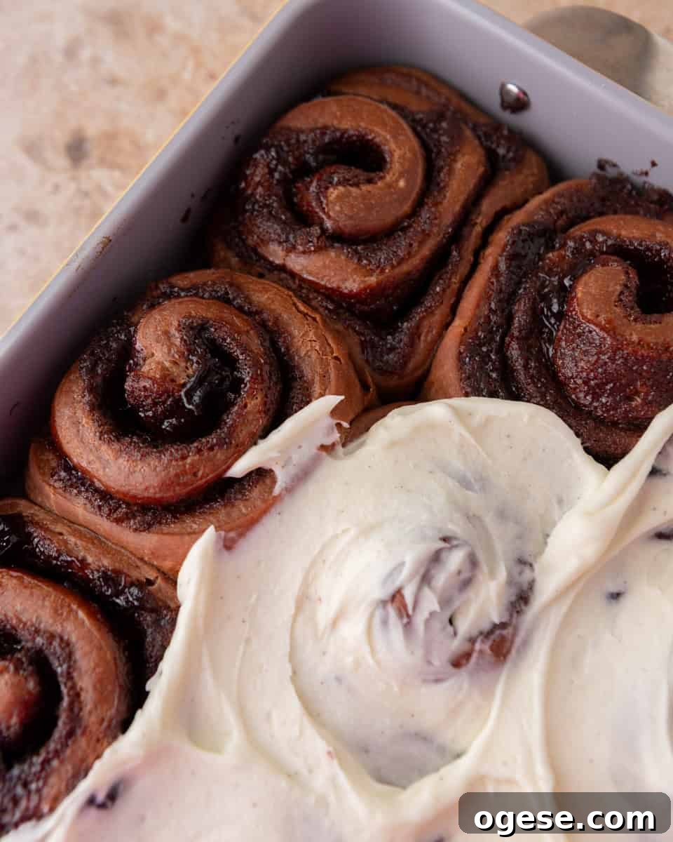 Frosting Black Forest cinnamon rolls with vanilla mascarpone frosting