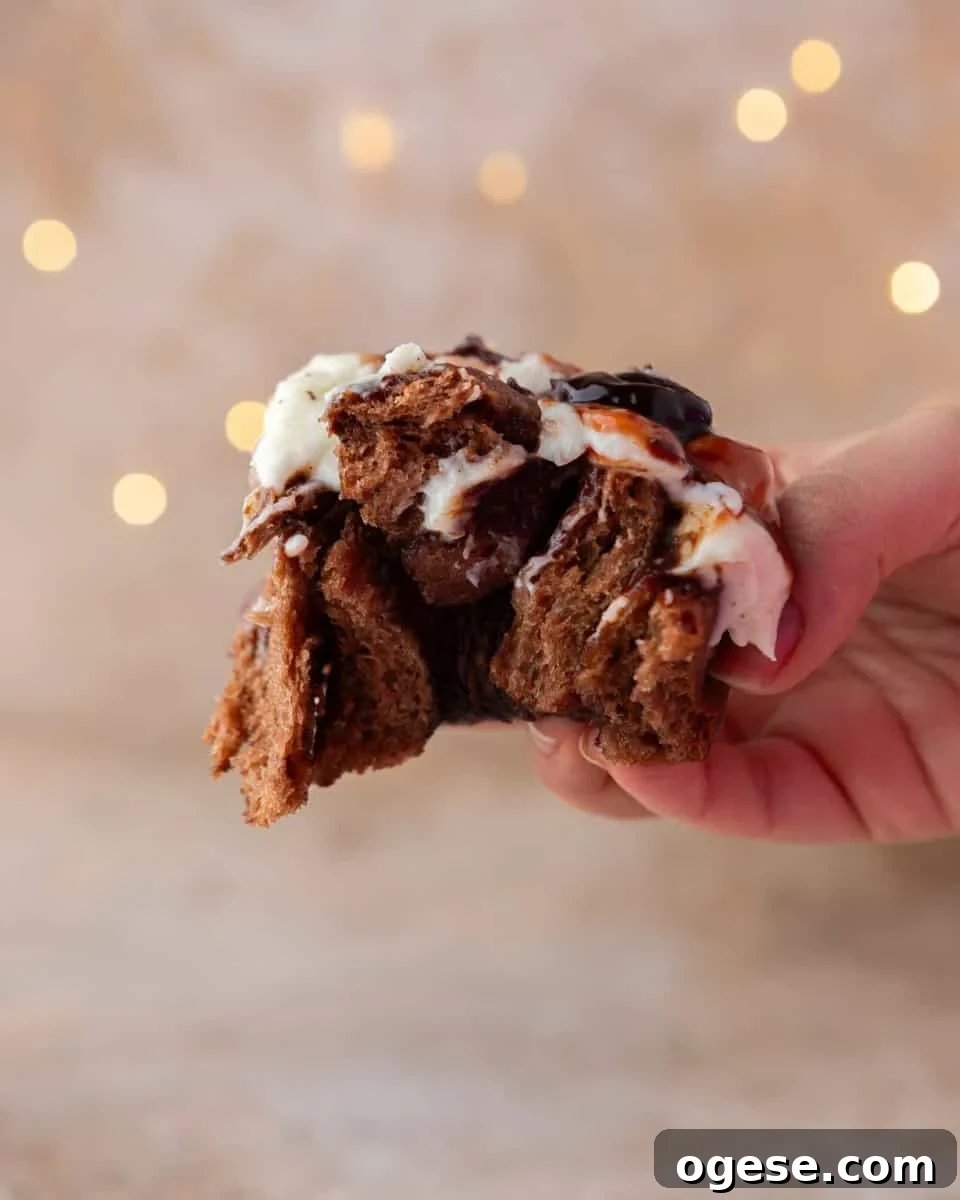 Hand holding broken in half chocolate roll