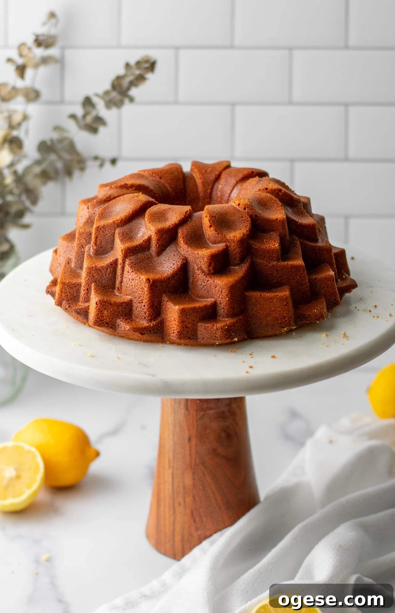Lemon bundt cake on a cake stand.