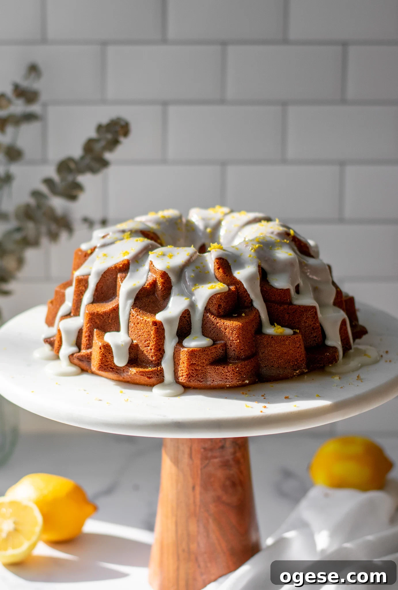 A lemon bundt cake on a cake stand.