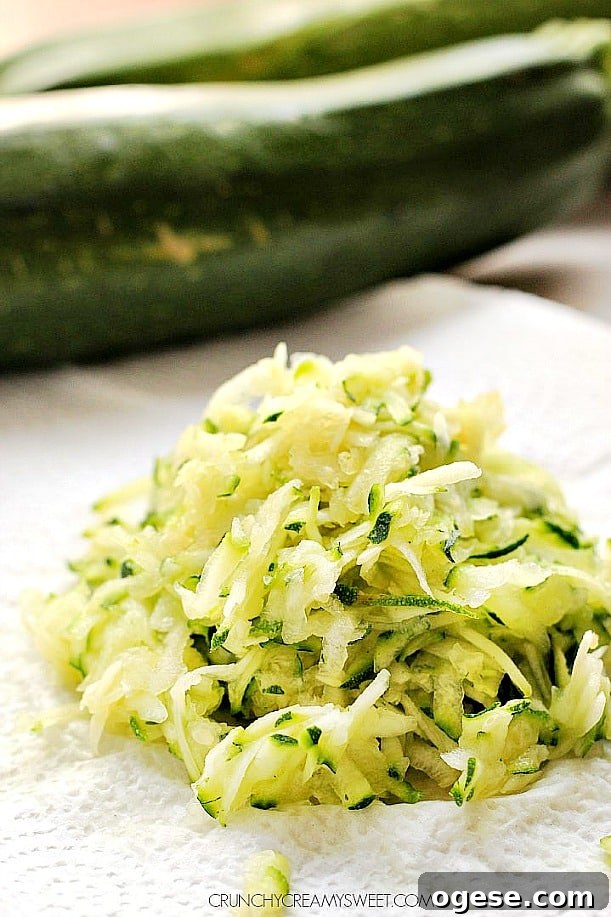 How to bake with zucchini and tips for best results. A mound of shredded zucchini on paper towel.