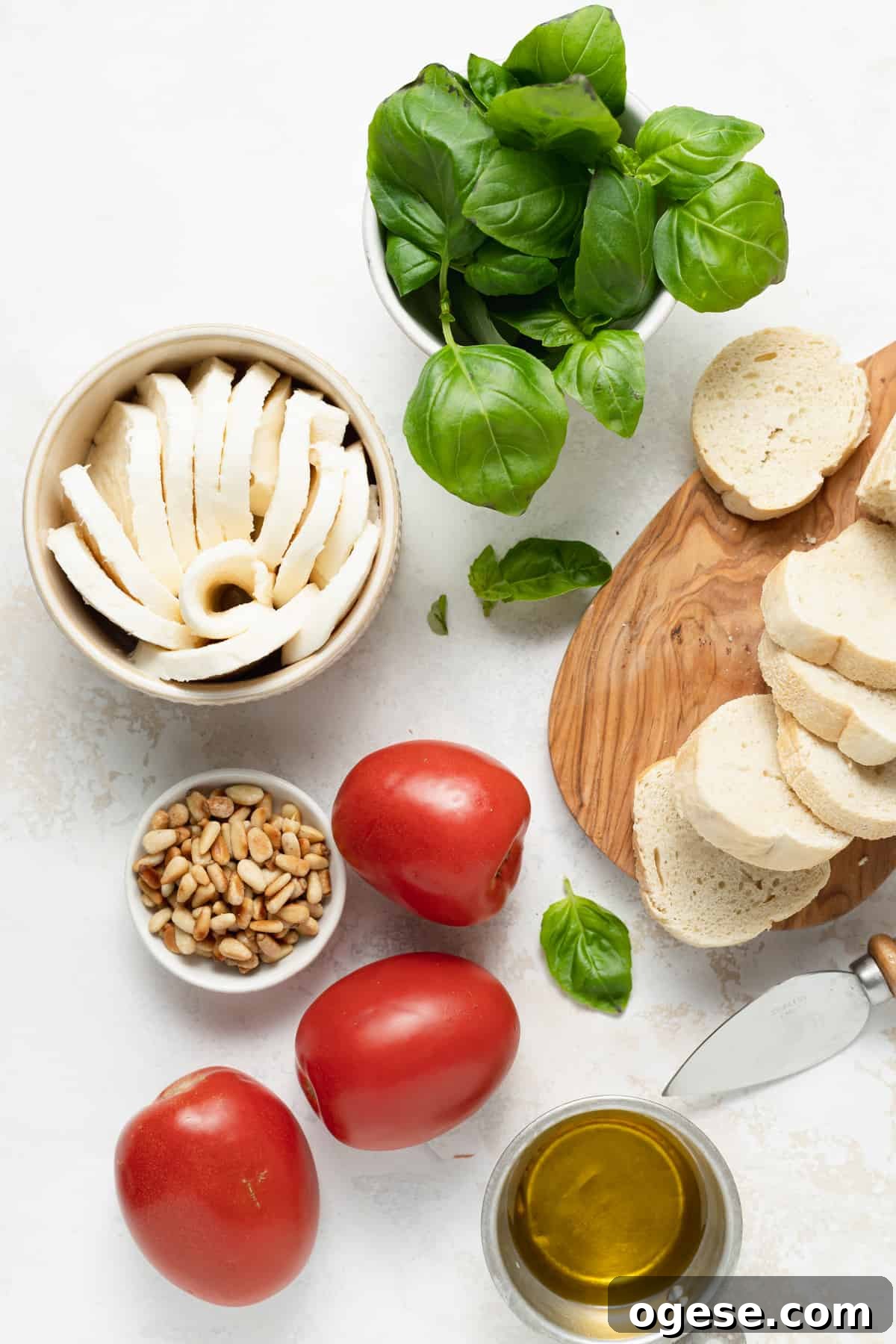 Classic Caprese Salad Recipe: Fresh Mozzarella, Tomatoes & Basil 3 Ingredients for a caprese salad laid out.