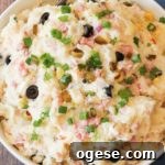warm potato salad in a white bowl