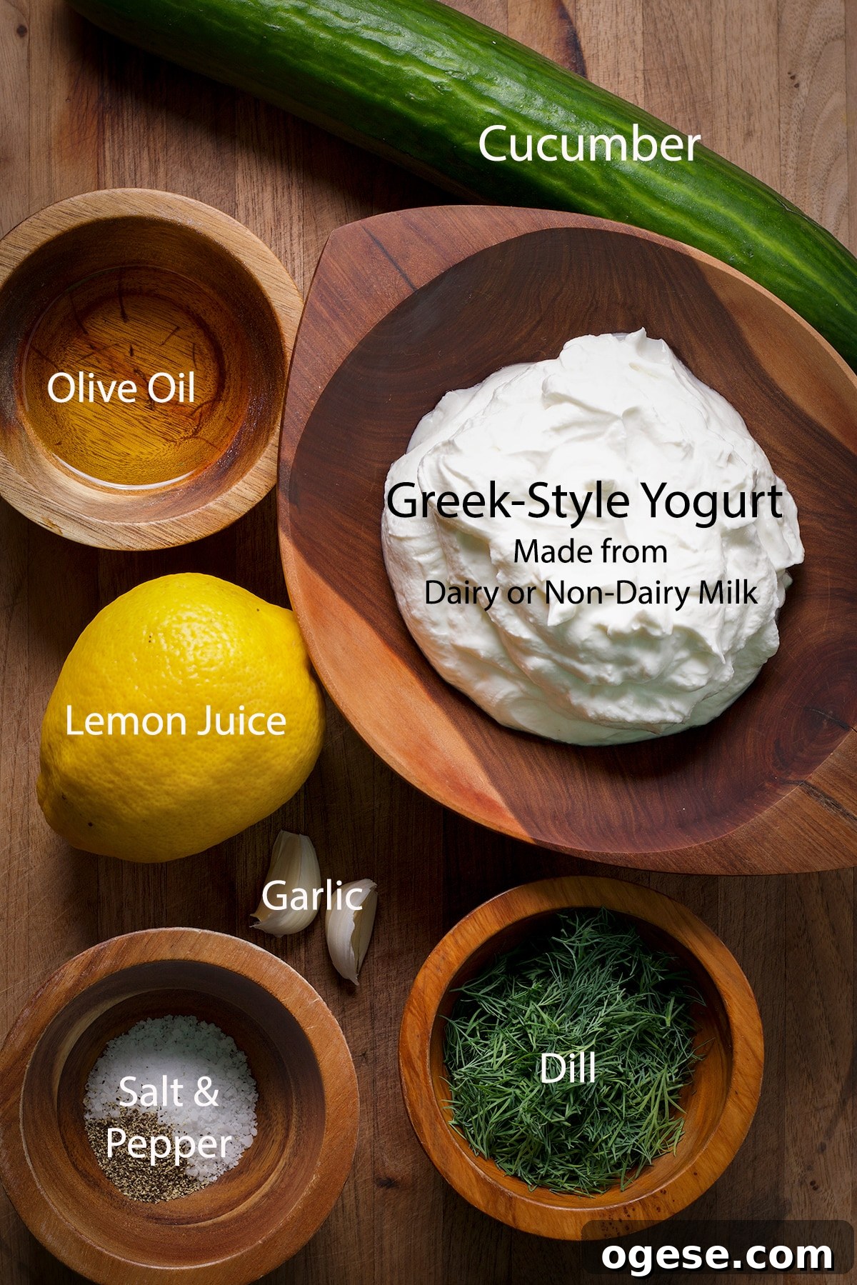 Traditional and Vegan Tzatziki: Two Authentic Recipes You’ll Love 3 All of the ingredients to make traditional or vegan tzatziki on a wood cutting board.
