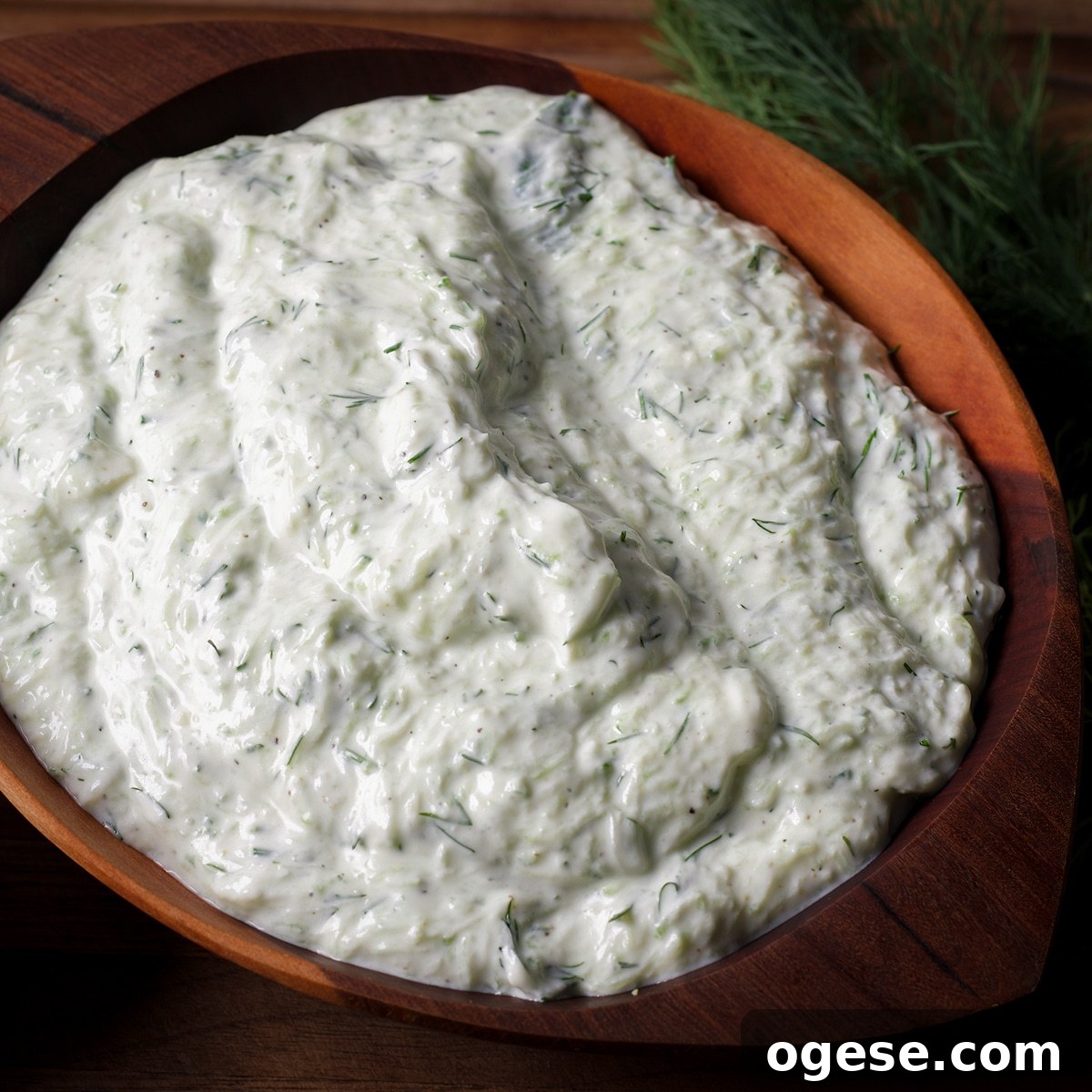 Traditional and Vegan Tzatziki: Two Authentic Recipes You’ll Love 7 A wood bowl containing homemade tzatziki sauce.