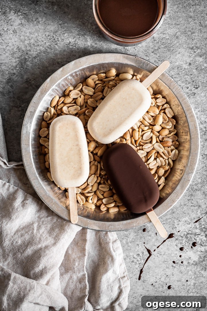 Ice cream bars in a tray filled with peanuts