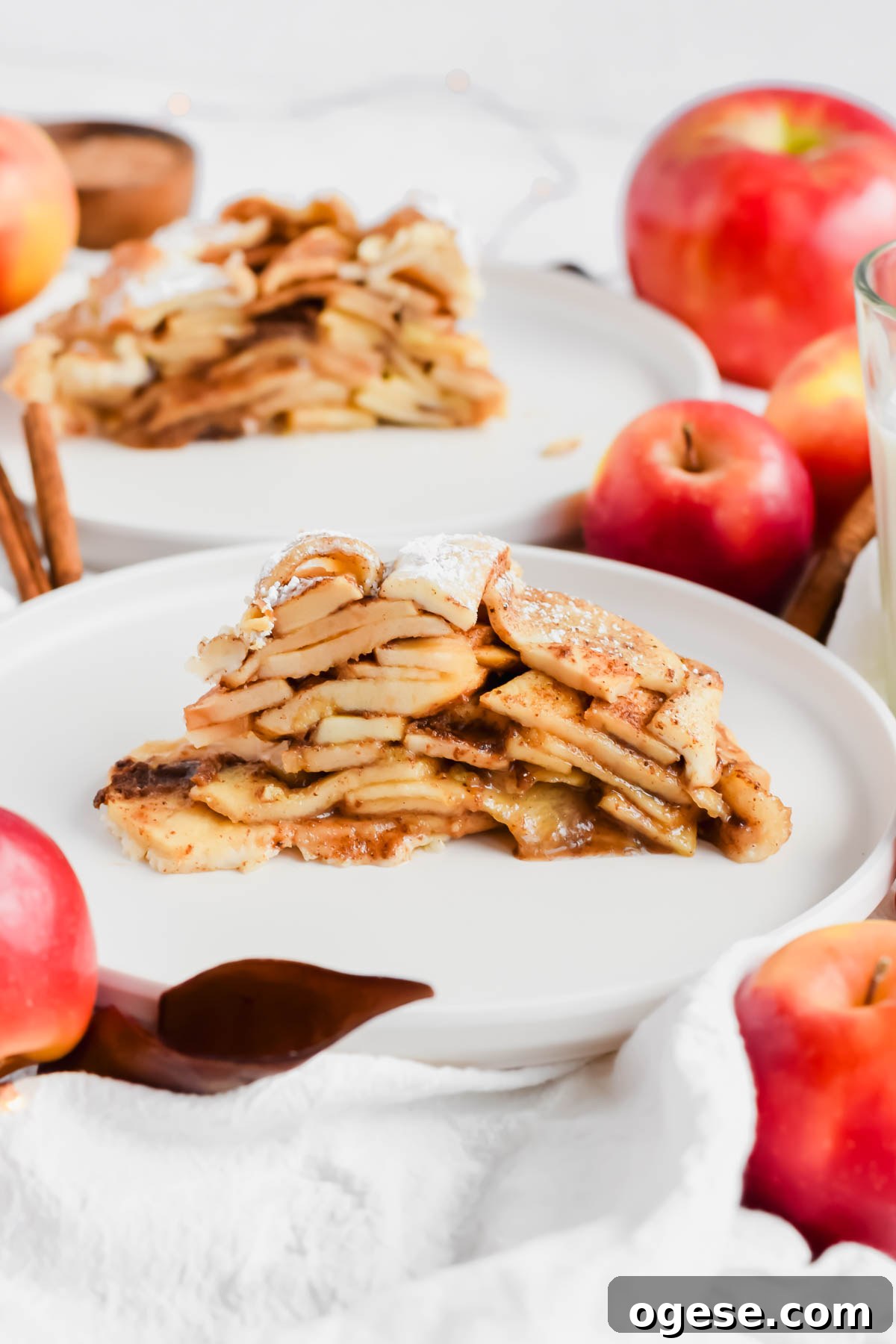 easy apple pie with store-bought crust on a white plate with additional slice in background.