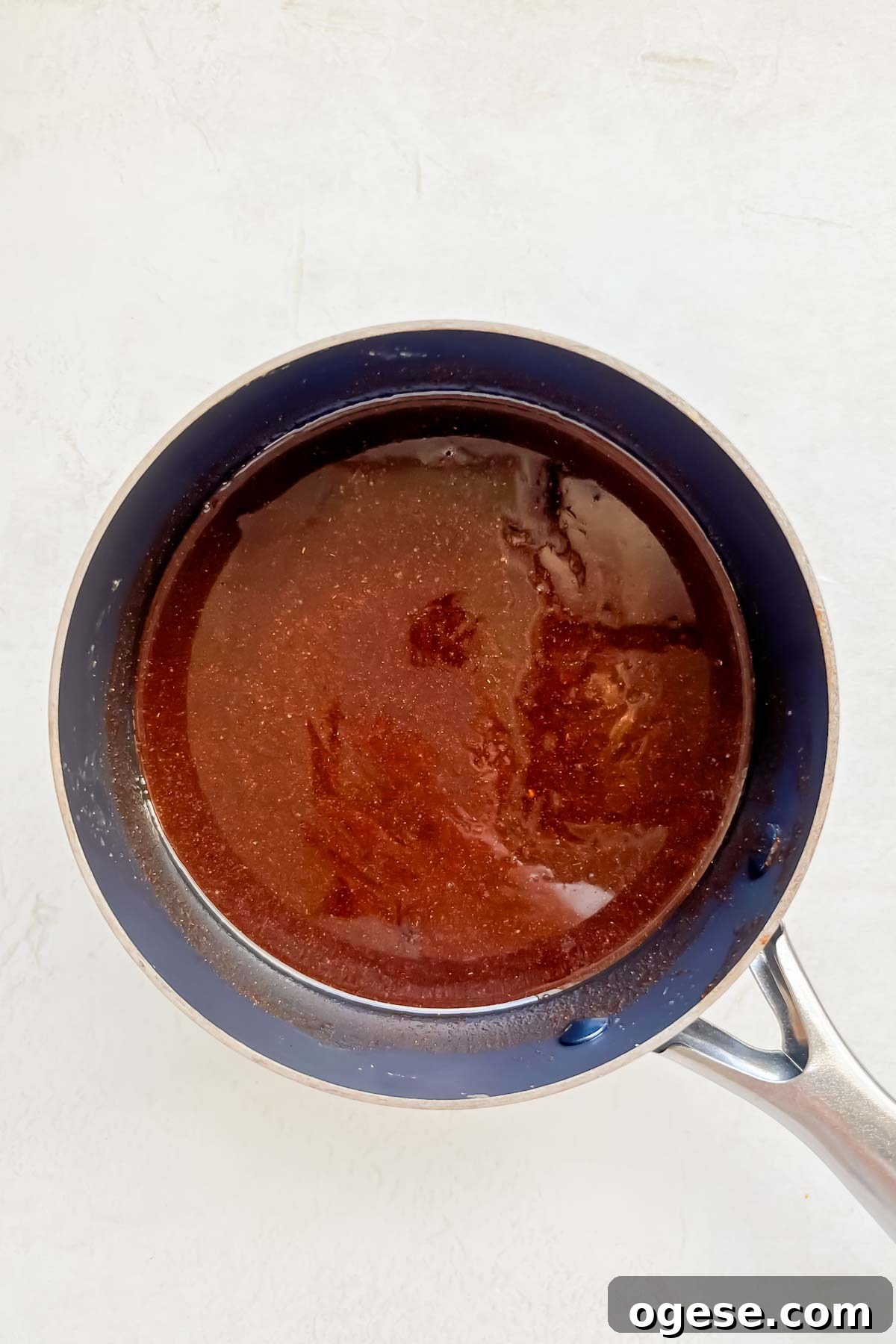 warm cinnamon mixture in small sauce pan on neutral background.