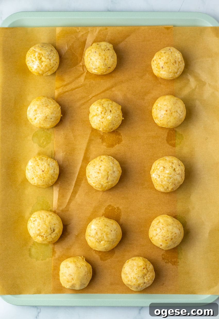 pecan pie truffles arranged in rows on a sheet of brown parchment paper