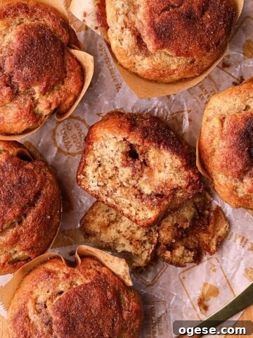 Cinnamon swirl banana muffins on a wooden board.