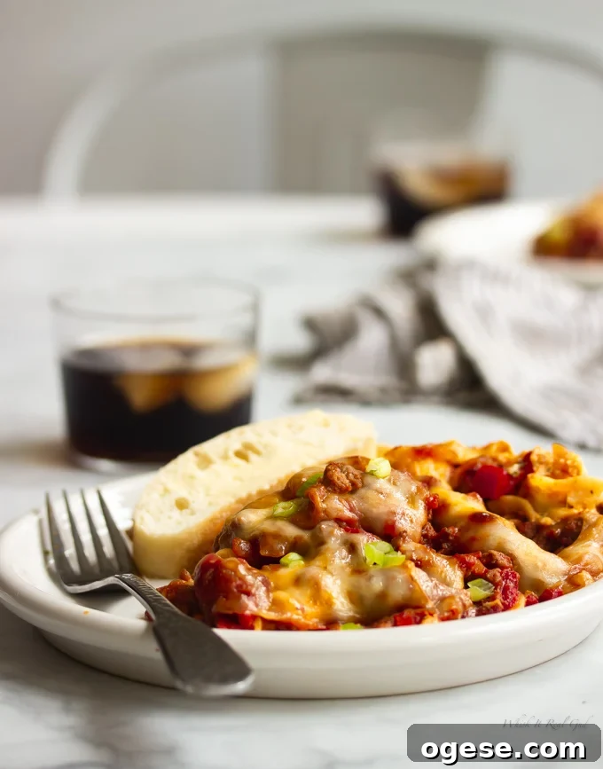 Homestyle Ground Beef and Egg Noodle Casserole (Video) 2 Ground beef casserole on a plate topped with green onions.