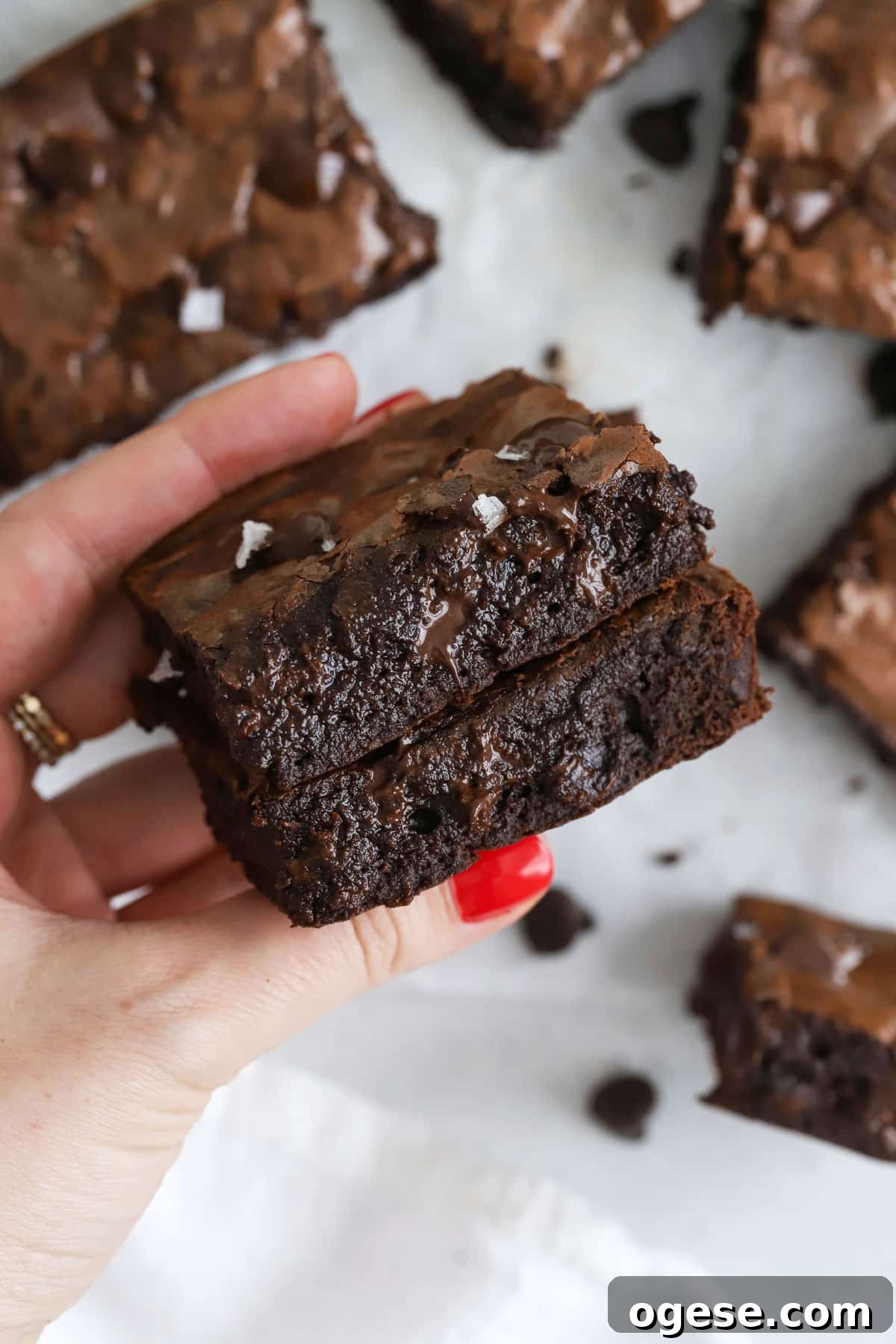 Holding small batch gluten-free brownies to show their fudgy texture