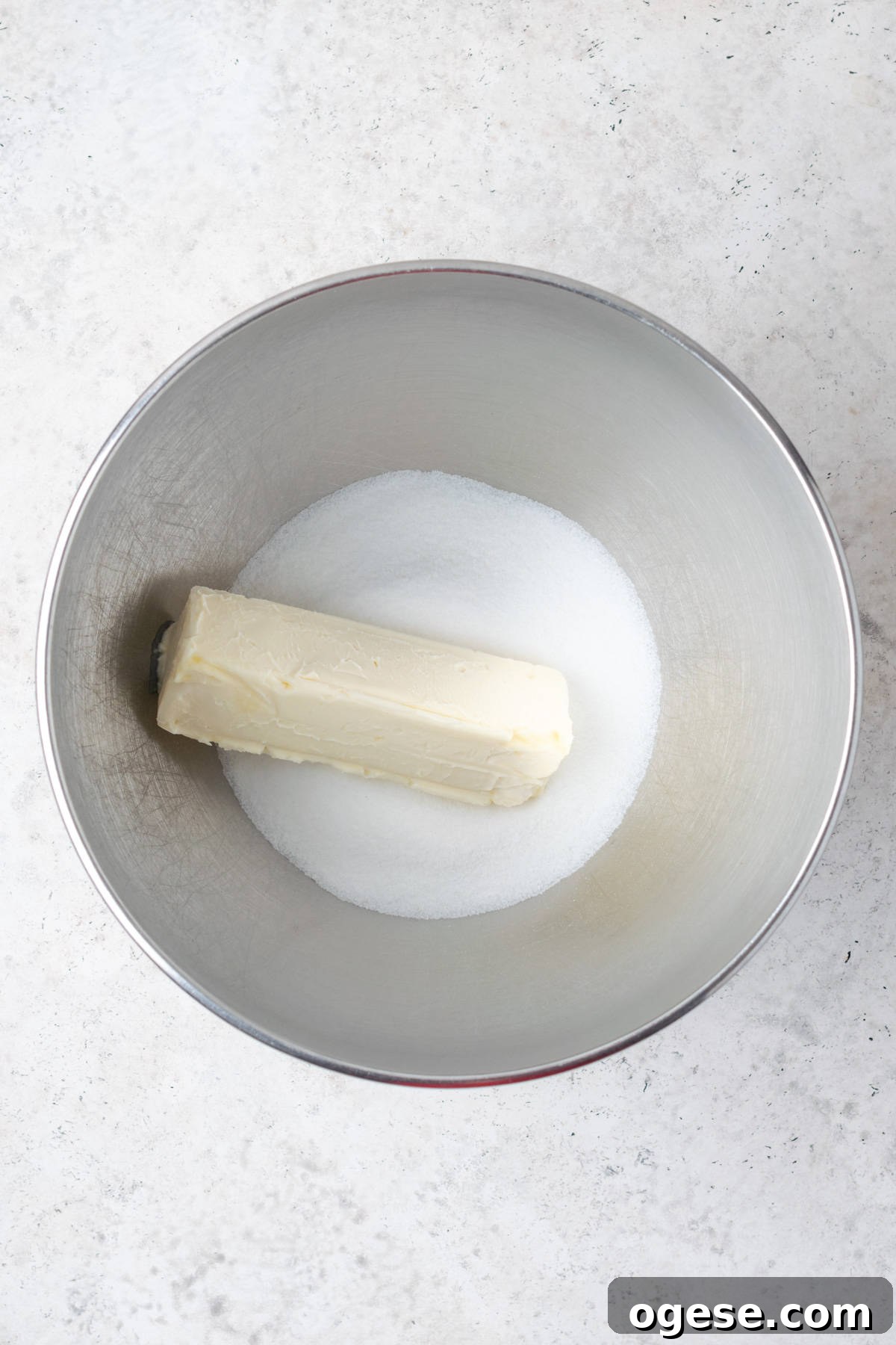 Butter and sugar combined together in a metal mixing bowl
