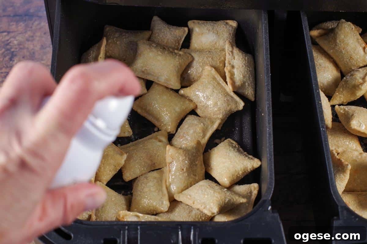 frozen pizza bites being sprayed with oil