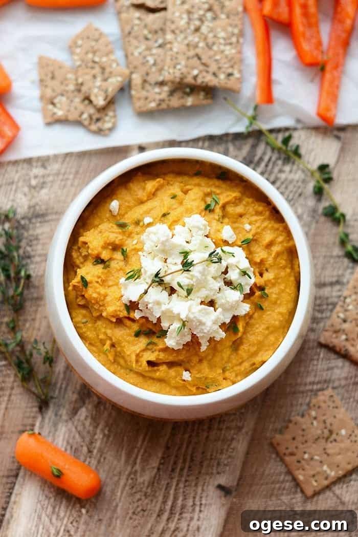 sweet potato hummus with goat cheese in white bowl