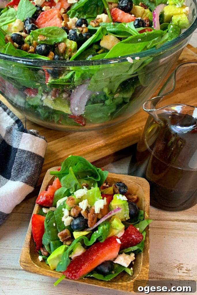 Close up of strawberry spinach salad to show off the ingredients.