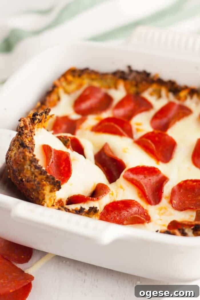 Low-Carb Taco Casserole with Cheesy Cauliflower Crust 17 keto pizza casserole in serving dish