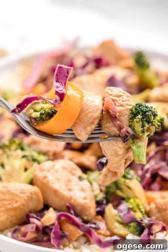 Low-Carb Taco Casserole with Cheesy Cauliflower Crust 25 closeup view of keto stir fry with piece of chicken and vegetables on a fork