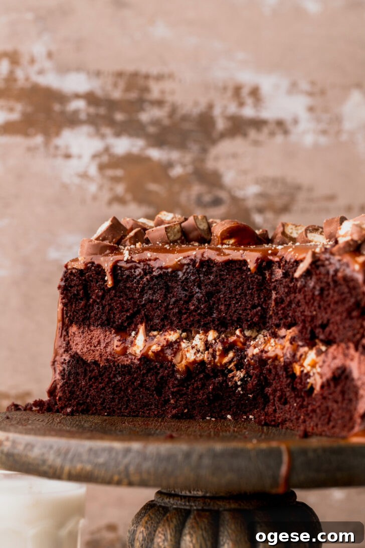Decadent Twix Bar Cake Recipe with Caramel and Chocolate 11 Close up of the side of cake.