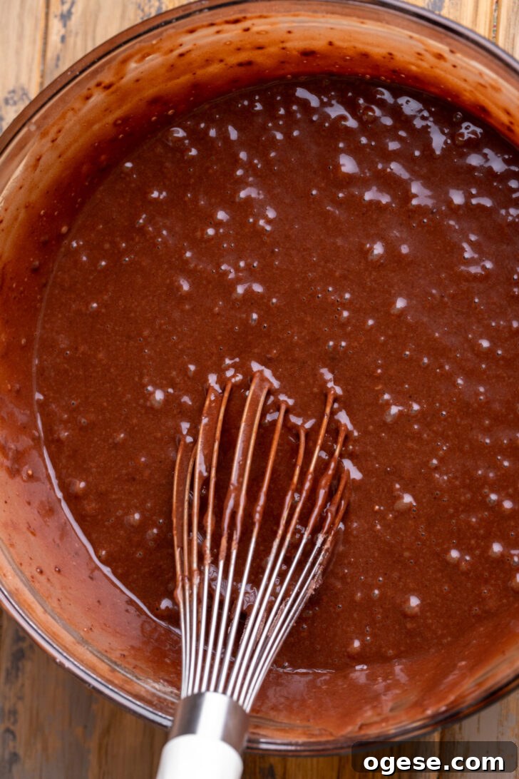 Decadent Twix Bar Cake Recipe with Caramel and Chocolate 4 Chocolate cake batter in a bowl.
