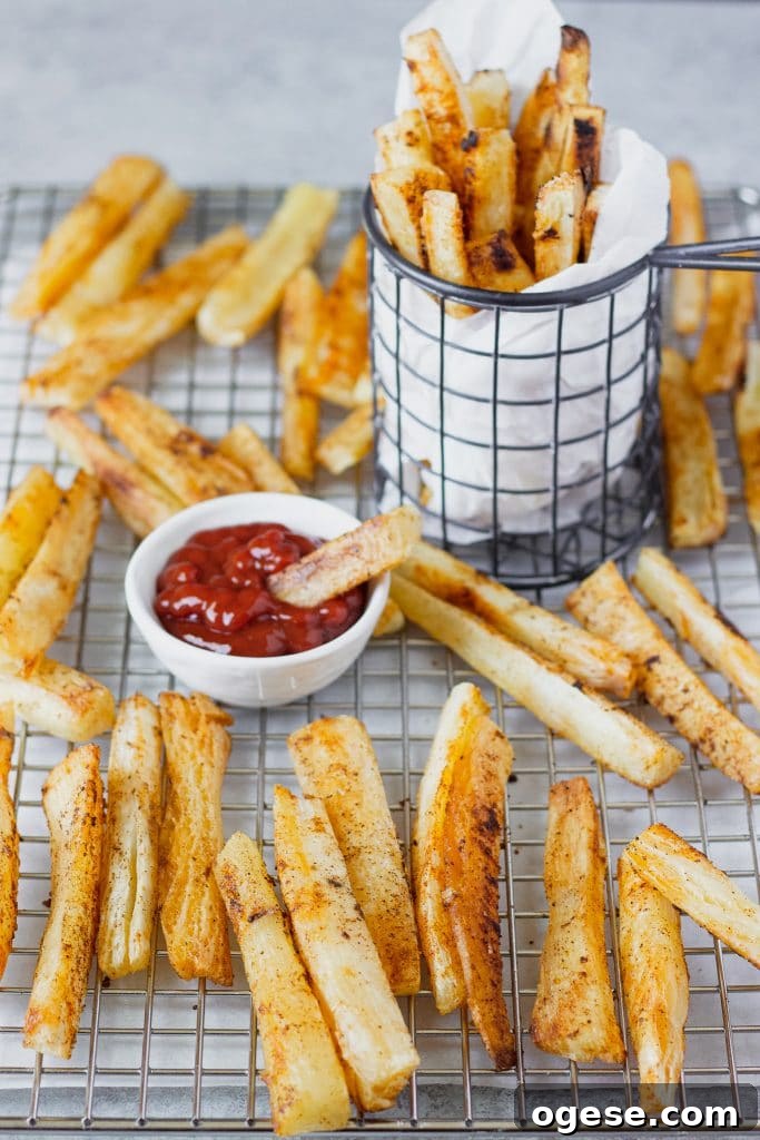 Crispy Baked Yuca Fries Recipe for Perfect Crunch 6 Baked slices of the yuca root in a cooling rack and a small container with dipping sauce