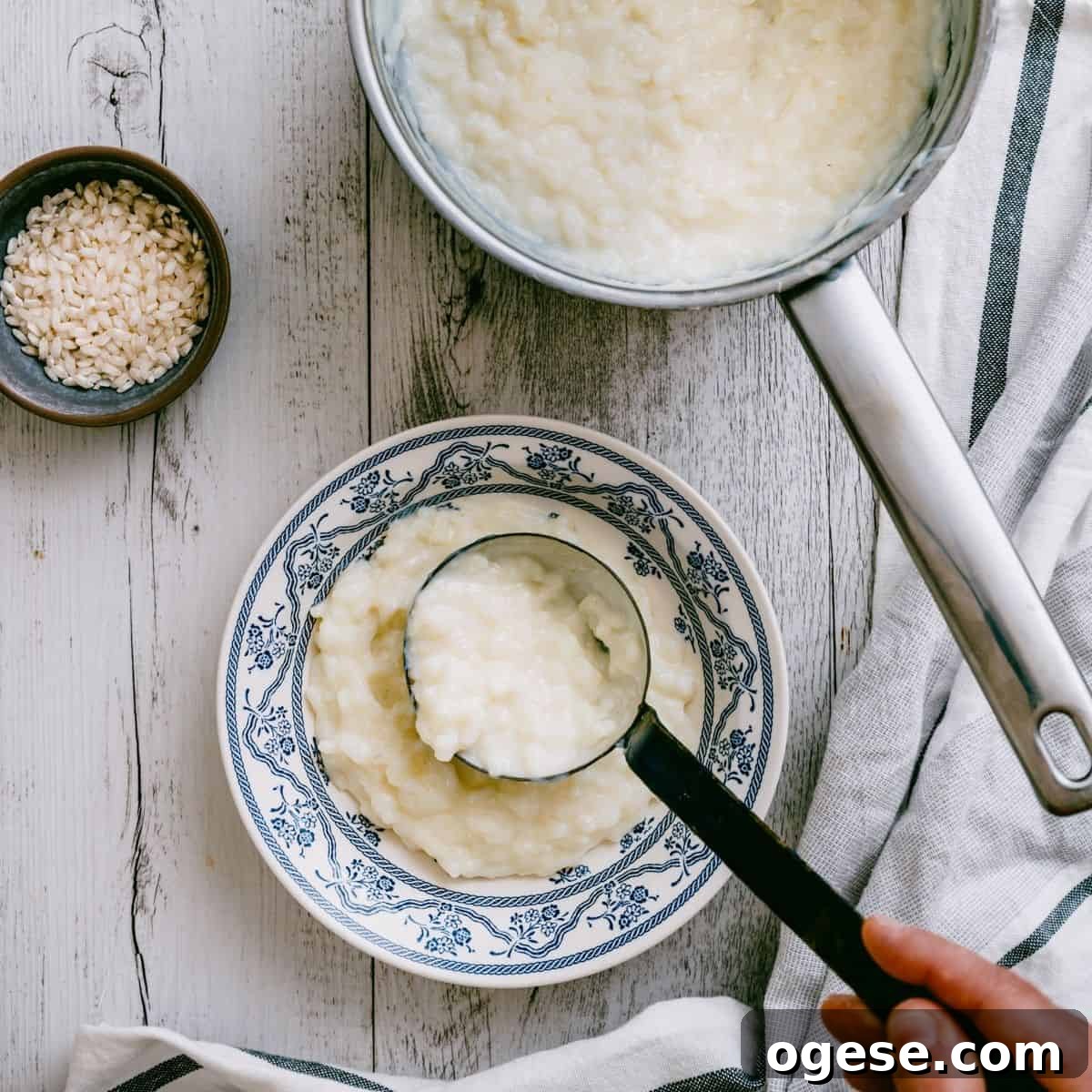 scooping Greek rice pudding into a bowl.