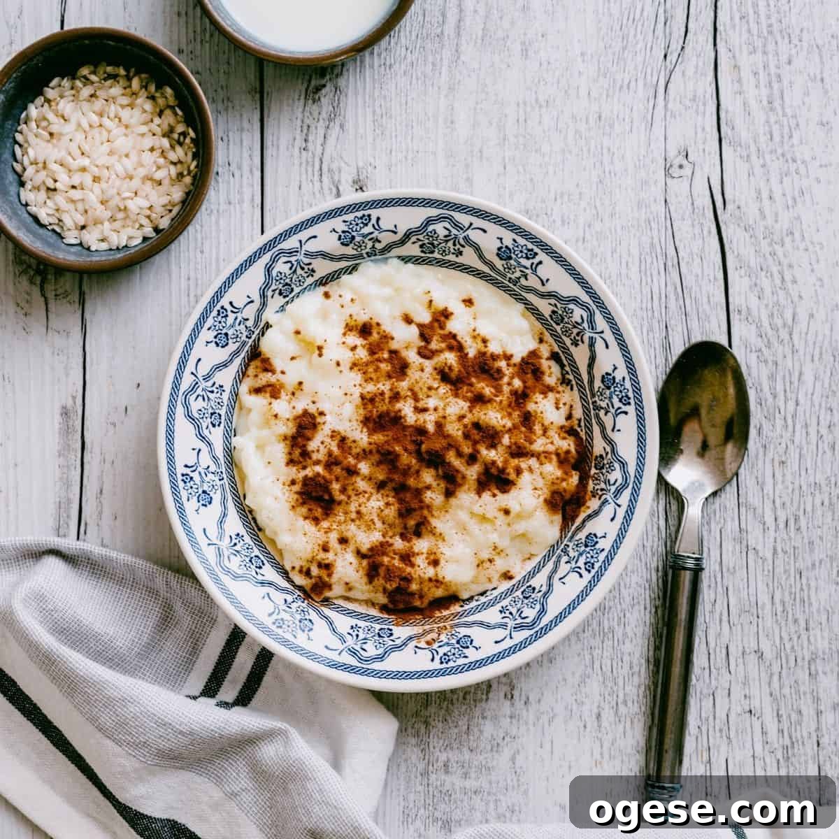Greek rice pudding served in a bowl and topped with ground cinnamon.