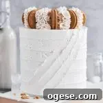 A white vanilla cake with diagonal stripes in the frosting.