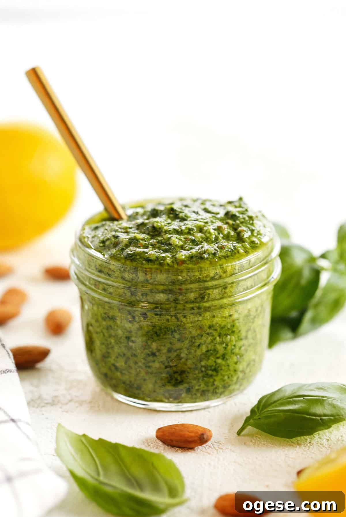 This Simple Basil Almond Pesto recipe combines fresh, delicious ingredients that is easily made in just 10 minutes! So versatile and perfect with pizza, pasta, chicken, shrimp or veggies!