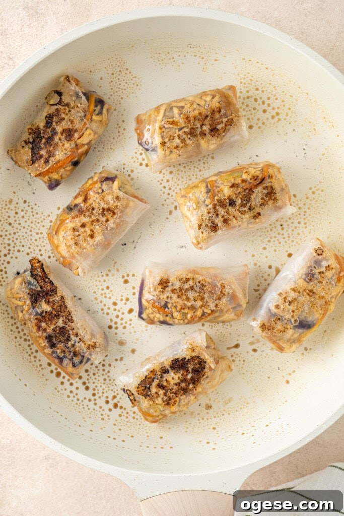 Crispy Rice Paper Dumplings Recipe — Crunchy Asian-Style Bites 9 Cooking the dumplings in a frying pan.
