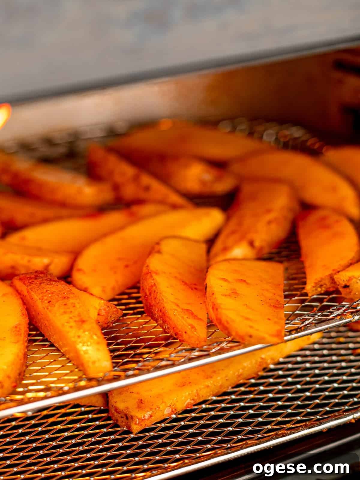 Potato wedges in an air fryer.