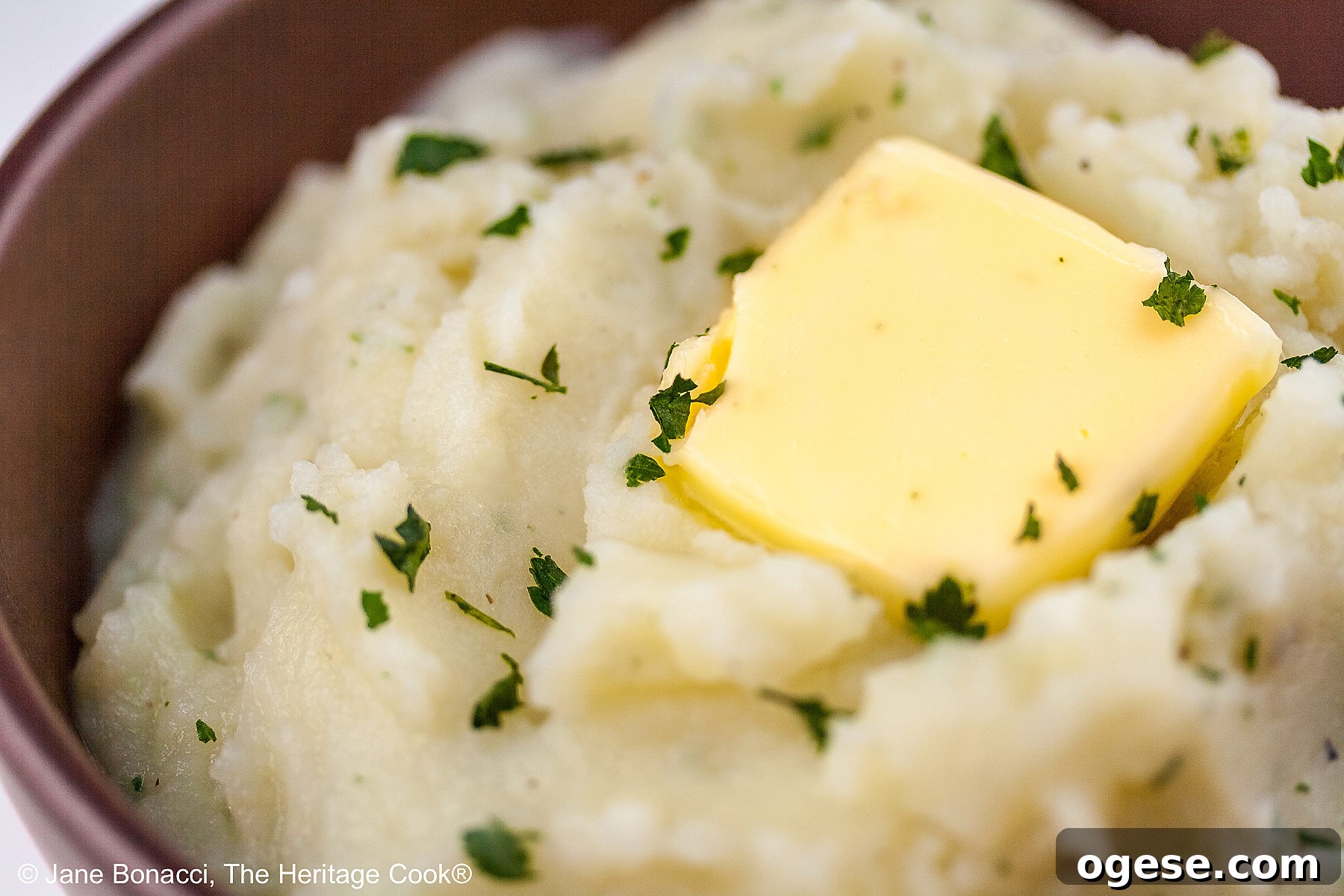 Red Wine-Braised Short Ribs (Gluten-Free) 5 Bowl of piping hot garlic mashed potatoes with a melting pat of butter on top with a sprinkling of parsley.