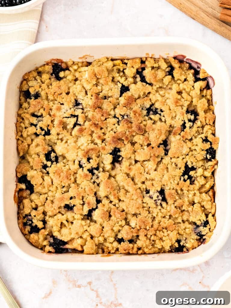 Golden apple berry crumble in a white dish.
