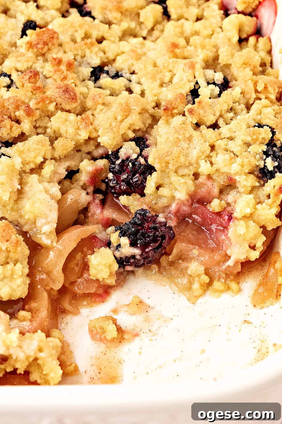 Baking dish with apple blackberry crumble; serving missing.