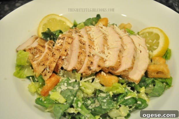 Easy Chicken Caesar Salad - The Grateful Girl Cooks! Grilled chicken breast is sliced, then fanned out on top of caesar salad before serving.
