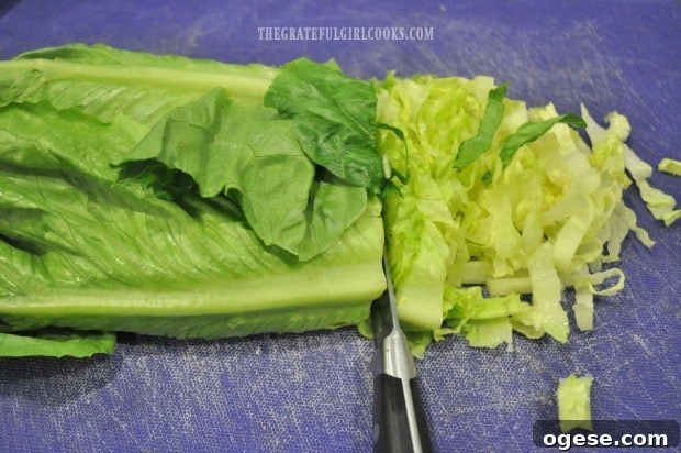Easy Chicken Caesar Salad - The Grateful Girl Cooks! Slicing romaine lettuce for chicken caesar salad.