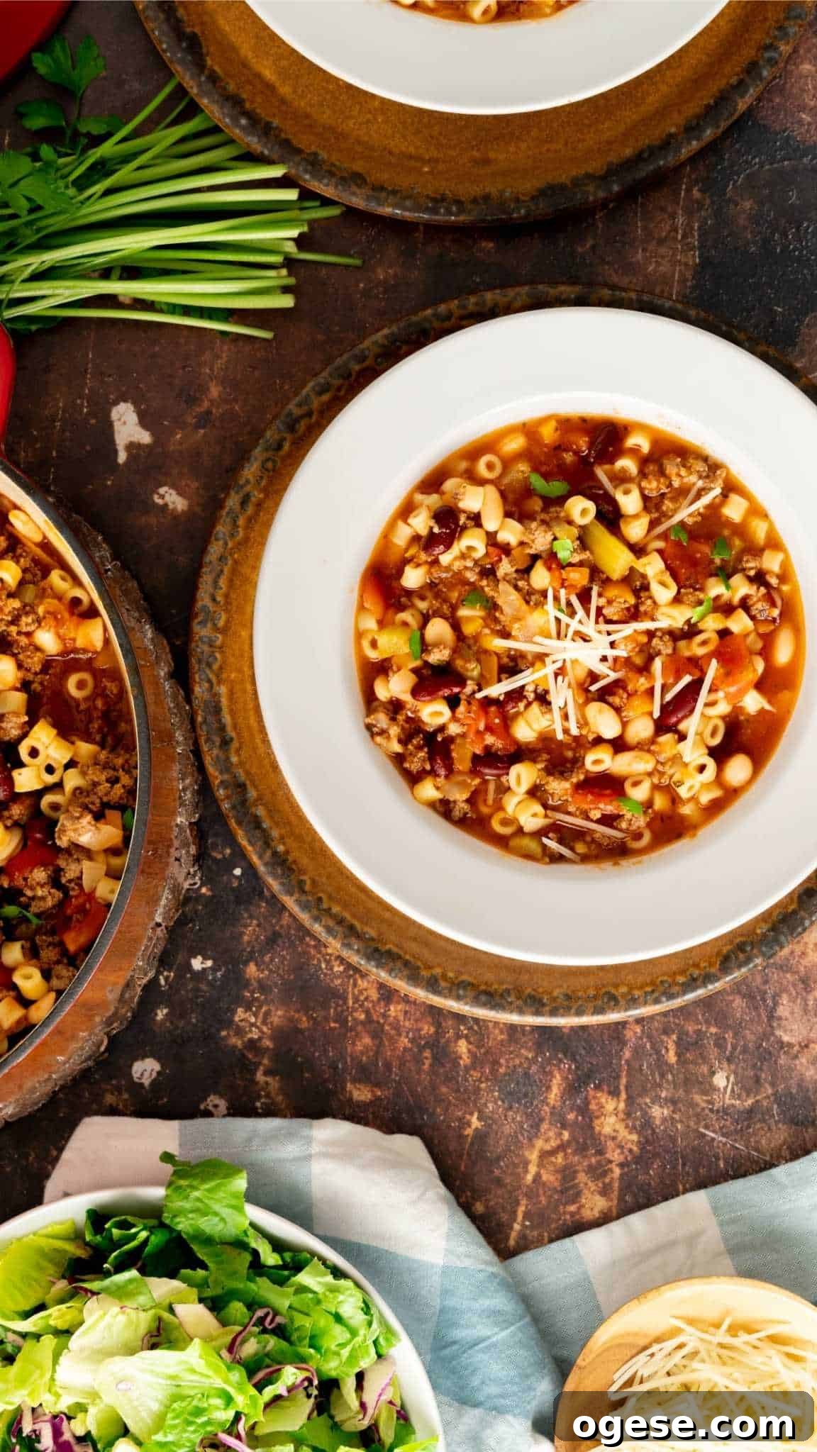 Instant Pot Pasta e Fagioli Soup: Quick Italian Comfort Meal 4 Pasta e Fagioli in a white rimmed bowl with with brown charger plate.