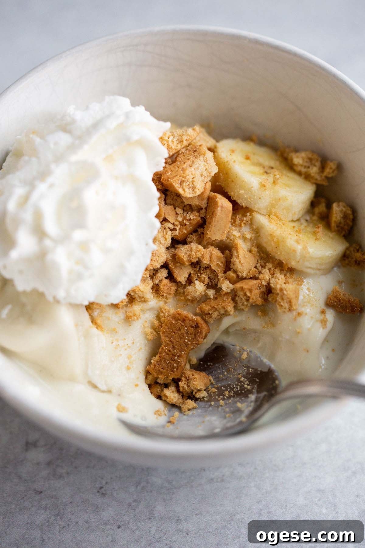 Make Banana Cream Pie Ice Cream in Your Ninja Creami 9 Ninja Creami banana cream pie ice cream topped with sliced bananas, graham crackers, and whipped cream